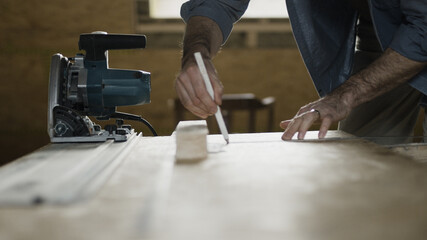 Worker sketching on wood