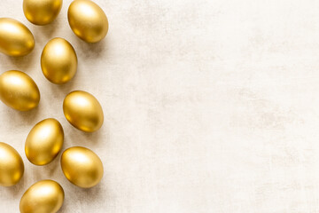 Golden eggs flat lay. Save money. Wealth and good luck symbol
