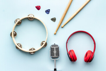 Flat lay musician concept - instrument with headphones, top view