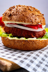 Tasty hamburger made with vegetarian plant based imitation minced meat burger and fresh vegetables