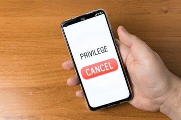 Privilege - Hand holding a Phone with cancel button