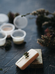 herbal soap, natural ingredients. samples of cosmetics on a dark background