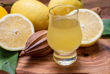 Ice cold sweet limoncello liqueur made from new harvest of fresh ripe yellow Italian lemons, Amalfi...