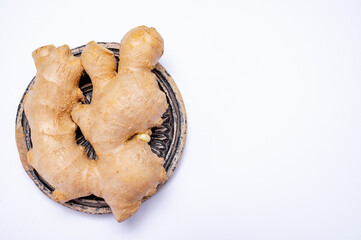 Fresh ginger rhizome root used in traditional medicines and for flavoring meals isolated on white