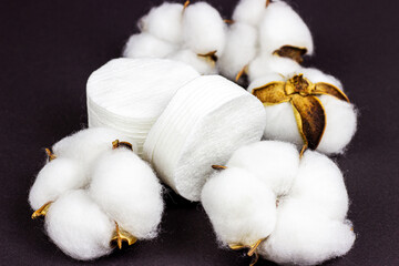 White soft cotton pads for hygiene and healthcare on black background.