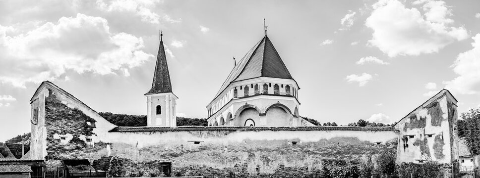 Medieval evangelical saxon fortified church of Cloasterf village in Mures county, Transylvania, Romania in black and white