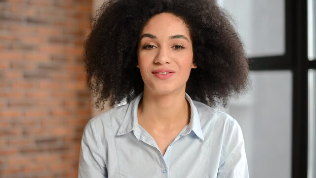Video call with a young mixed-race female employee, friendly biracial woman looking and talking into a camera. Video conference with a confident multiethnic colleague