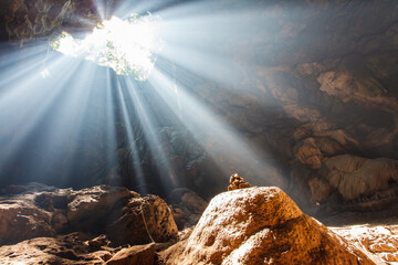 Sun Beams Shine Down Through Cave - obrazy, fototapety, plakaty