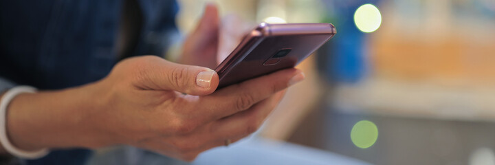Person holds smartphone in his hands and moves his finger across screen. Communication in messengers concept