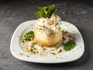 Closeup dessert baked apple with nuts in cream