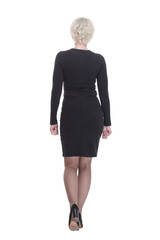 Fototapeta premium business woman in a black dress walking away. isolated on a white background.
