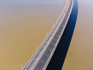 Fototapeta premium Aerial view of beautiful Vasco da Gama bridge's suspended highway road crossing the Tagus river, one of the world's longest bridge, Oriente district, Lisbon, Portugal.