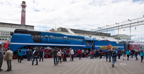  Passengers sit in cars, driven by a steam locomotive P 36 