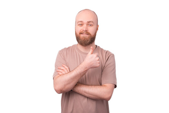photo of handsome man with beard in t shirt showing thumb up over white background