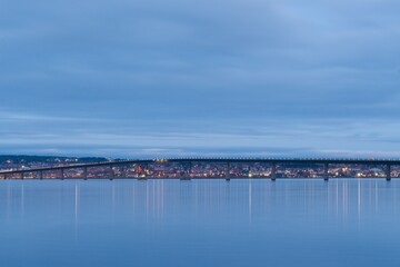 Vallsundsbron bridge over Lake Storsjön with the city of Östersund in the background just after sunset