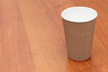 three empty cardboard cups on a wooden background