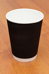 three empty cardboard cups on a wooden background