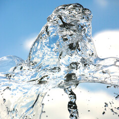 
Water fountain. Close up of the splash in the air. Blue sky with clouds