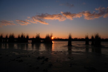 Fototapeta na wymiar Sunset over the lake with beautiful sky