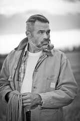 Farmer on the field wearing hat and work clothes	