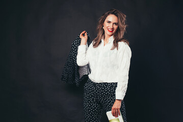 Portrait of charming business woman over black background.