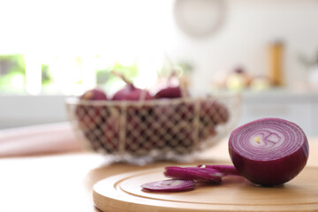 Cut red onion on wooden table in kitchen
