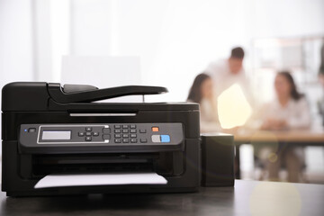 New modern printer on table in office. Space for text