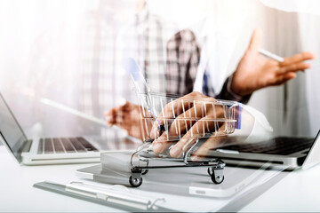 businesswoman hand using smart phone,mobile p payments online shopping,omni channel,digital tablet docking keyboard computer at office in sun light