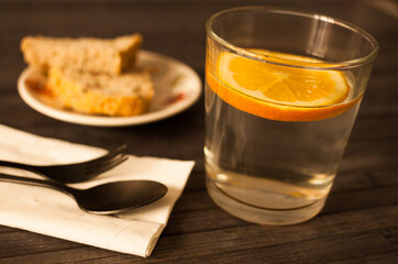 slice of orange in glass of water on the table