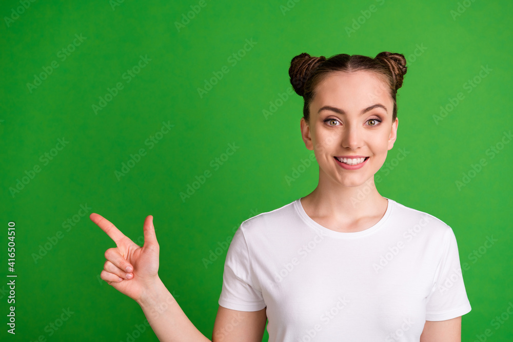 Poster Portrait of pretty cheerful girl demonstrating copy space select indicate isolated over vibrant green color background