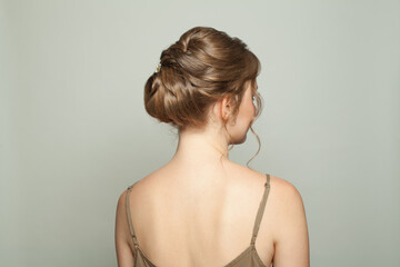 Beautiful female back with bridal hairdo, woman head and back on white background