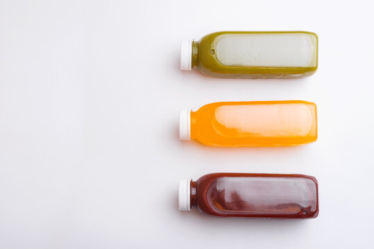 Top view photo of different detox juice bottles, antioxidant and daily vitamins you need.