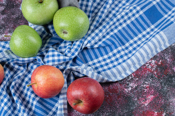 Red and green apples isolated on a blue checked towel