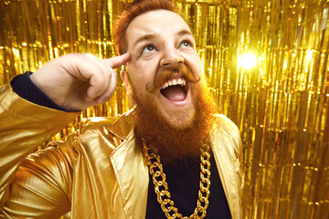 Excited young showbiz performer screaming for joy at a concert. Happy man with beard and handlebar...