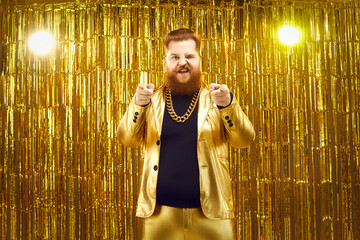 I choose you. Portrait of extravagant chubby young man in funky golden suit, with gold chain around...
