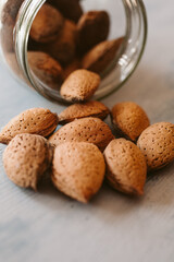 Almonds in a jar on wooden rustic table as background. Close up view.	