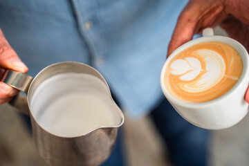 unrecognizable person preparing coffee in cafeteria