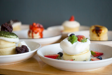 Japanese-style pancakes on a wooden table are ready to serve.