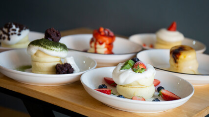 Japanese-style pancakes on a wooden table are ready to serve.