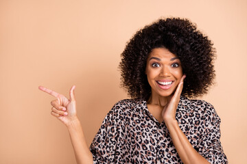 Photo portrait of amazed girl touching cheek pointing finger blank space advising isolated pastel...