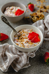 Creamy ricotta, yoghurt with strawberries and granola. Healthy breakfast. Farm dairy products. Eco-friendly healthy high-protein food.