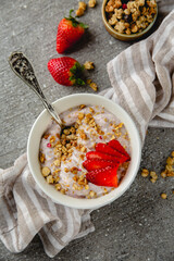 Creamy ricotta, yoghurt with strawberries and granola. Healthy breakfast. Farm dairy products. Eco-friendly healthy high-protein food.