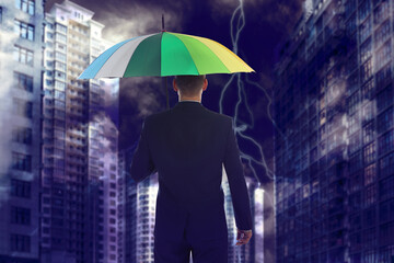 Businessman with umbrella in city center. Insurance concept