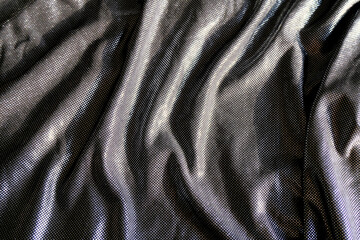 Gray sparkling dress fabrics close-up. Top view. Party style. Celebration. Female elegant style. Abstract bright background