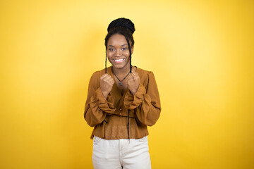 African american woman wearing casual clothes very happy and excited making winner gesture with raised arms, smiling and screaming for success.