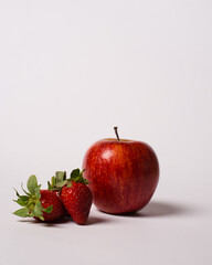 Ripe apples and strawberries isolated on white background. Nutritious fruit that is rich in vitamin C. Suitable for fresh juice. Ready to eat in the morning before starting the activity.