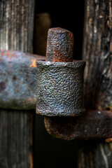Aged wooden door with old rustic ironmongery, shackle, hasp & staple. Red door. Old metal rusty hinges on the wooden boards covered with multilayer shelled with green and turquoise paint
rusted forge
