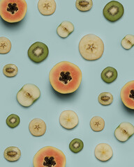 Layout of assorted fresh fruit. Papaya, apple, kiwi isolated on blue background. Summer concept for a fruit diet. Summer fruits are perfect for juicing. Healthy fruit with vitamins. Fruit wallpapers