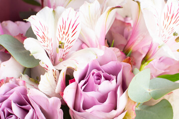 beautiful bouquet of Alstroemeria and purple roses. Fresh, lush bouquet of colorful flowers