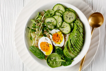 bowl with quinoa, greens, avocado and boiled egg